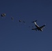 Paratroopers descending from aircraft