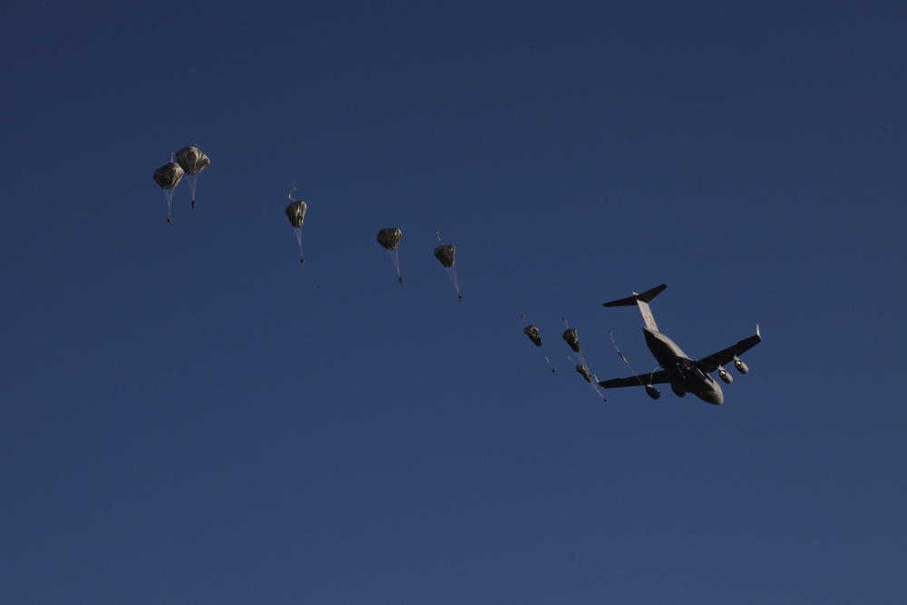 Paratroopers descending from aircraft