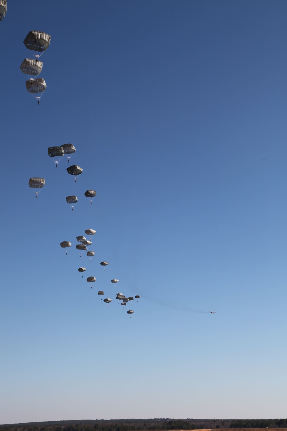 Paratroopers descending from aircraft