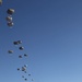 Paratroopers descending from aircraft