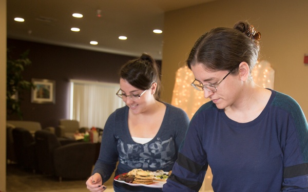 Military spouses exhange cookies and ornaments
