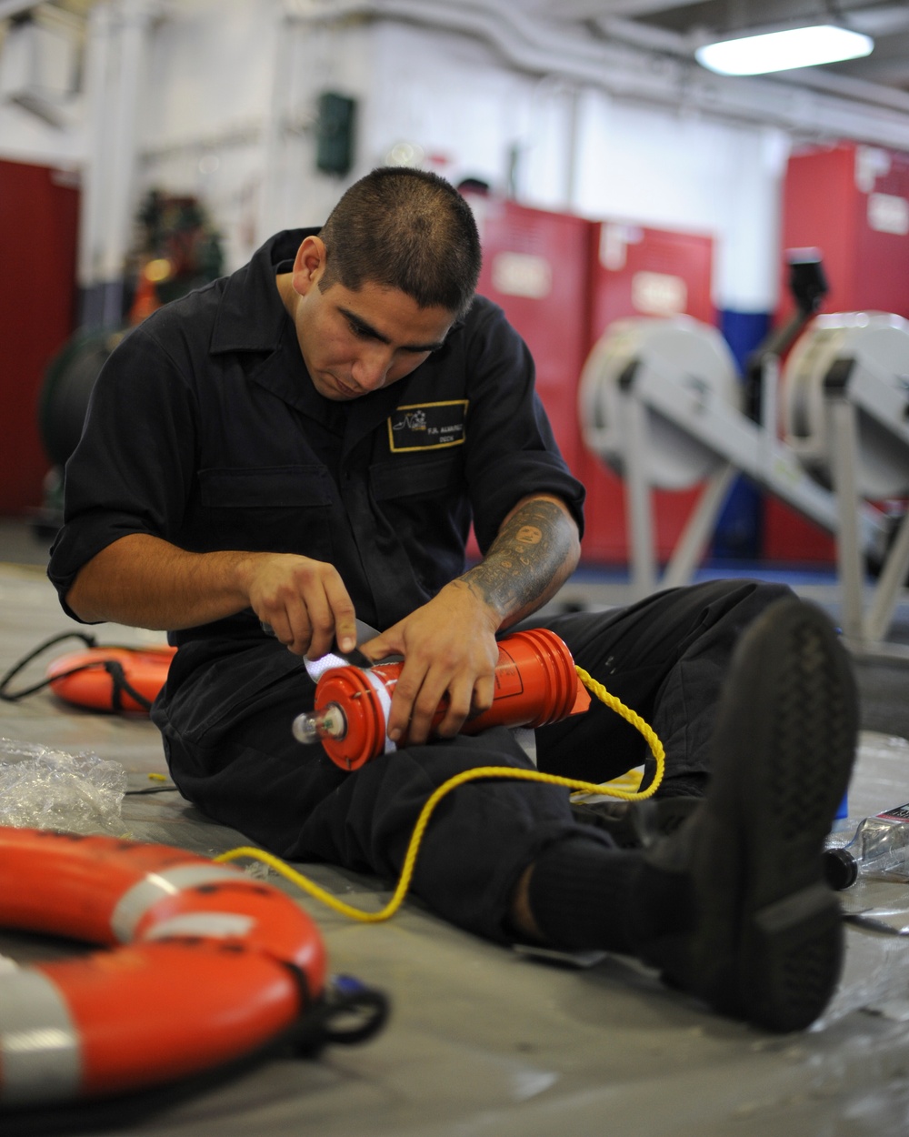 Sailor performs maintenance on life ring