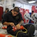 Sailor performs maintenance on life ring