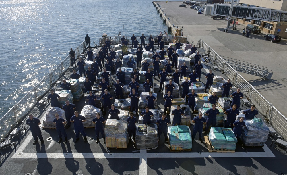 Coast Guard Cutter Hamilton crew stand next to 26.5 tons of cocaine