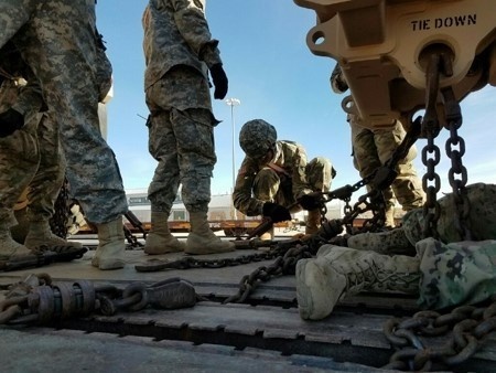 Soldier secures vehicle during rail load ops