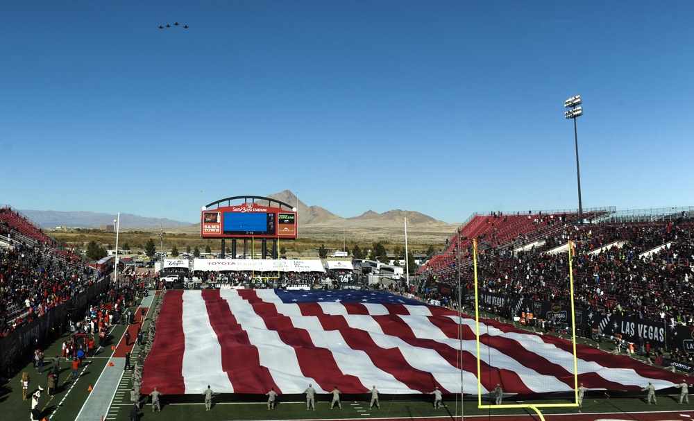 Nellis, Creech Airmen raise American Flag during Las Vegas Bowl