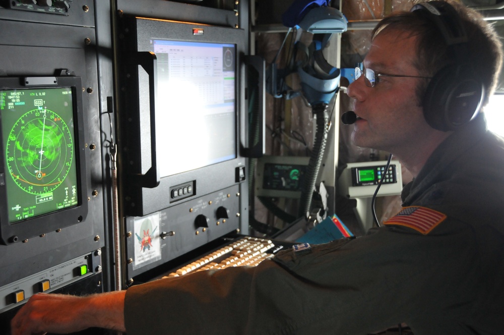 Lt. Col. Brian Schroeder, 53 Weather Reconnaissance Squadron aerial reconnaissance weather officer, scans the radar while flying through Hurricane Odile off of the West Coast of Mexico. This was the first mission to into the storm headed for the Baja Pene