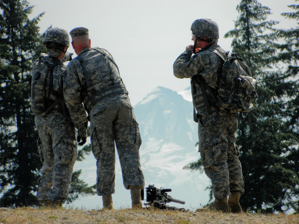 Army Reserve soldiers check downrange for obstructions while Mount Rainier looms in the background