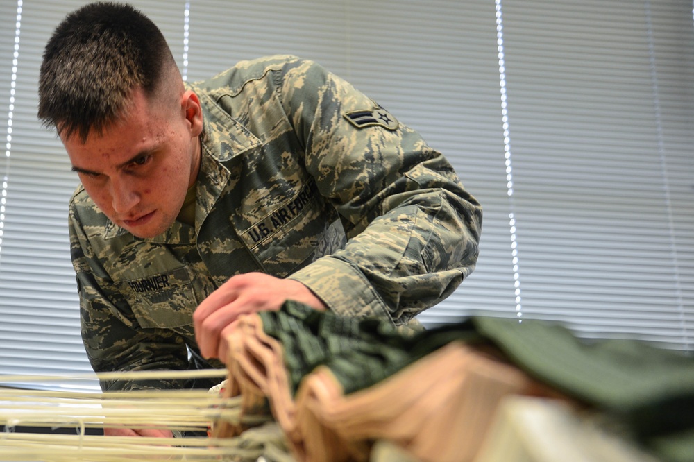 AFE Airmen inspect parachutes