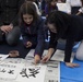 Station residents, Japanese locals brush past 2016 with calligraphy