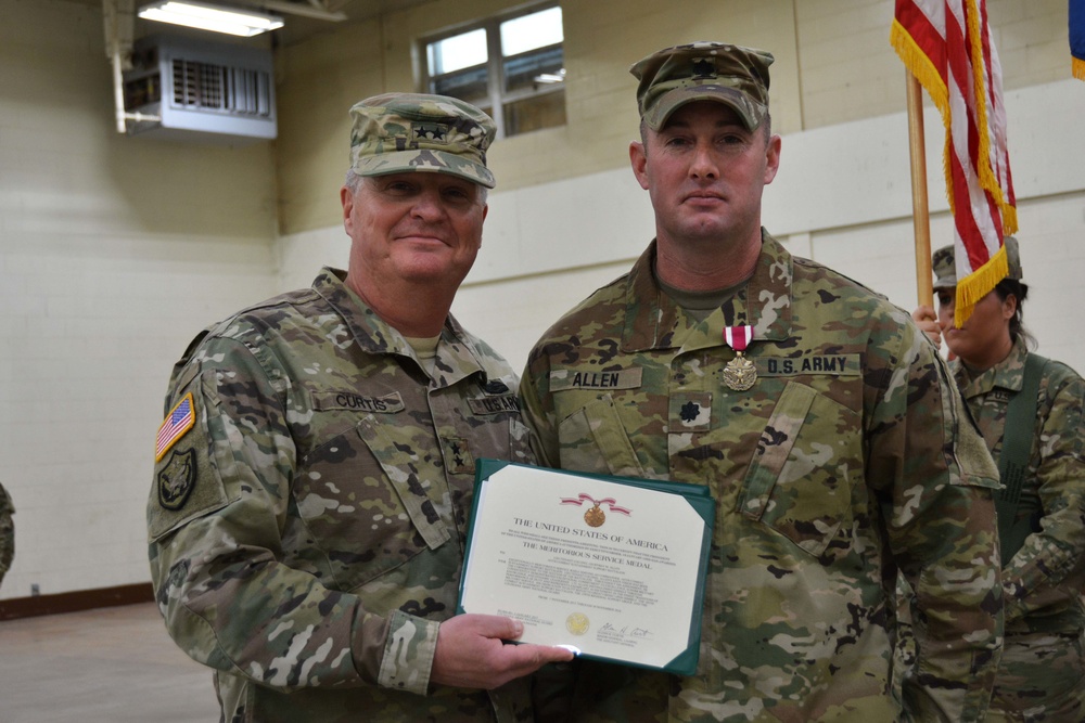 Maj. Gen. Glenn H. Curtis, adjutant general of the Louisiana National Guard, presents the Meritorious Service Medal to outgoing commander Lt. Col. Geoffrey M. Allen.
