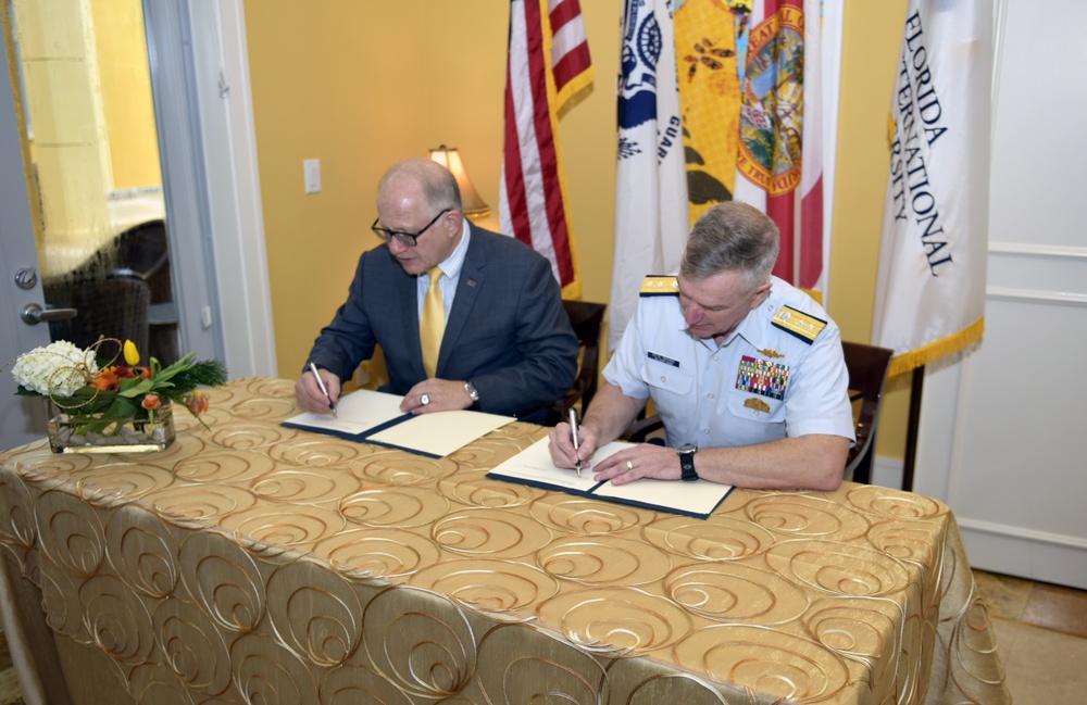 Coast Guard Rear Adm. Peter Brown and Mark Rosenburg sign a Memorandum of Agreement
