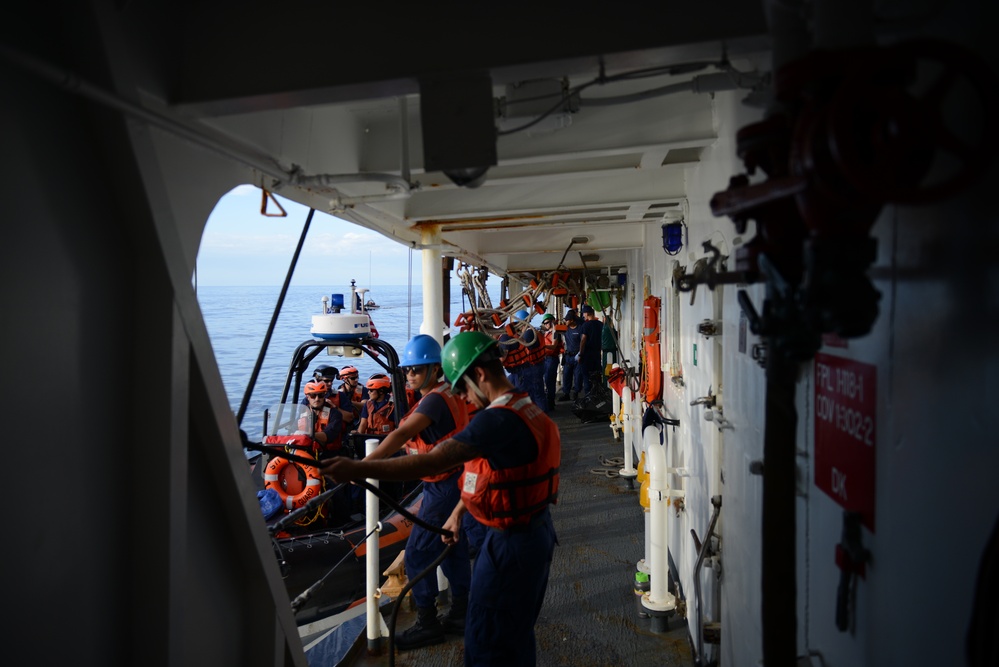 Crewmembers from the Coast Guard Cutter Sherman recover cutter’s small boat