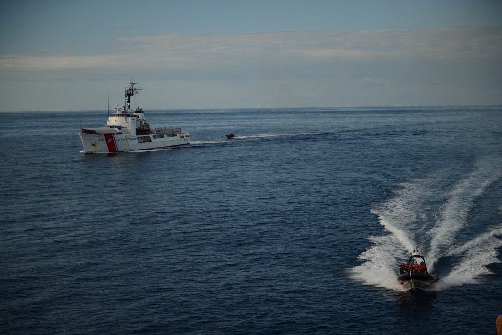 Small boats from Coast Guard Cutters Diligence, Sherman underway i