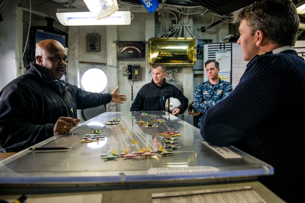 Lt. Cmdr. Freddie Koonce, from Kinston, North Carolina, explains flight deck operations to Commodore Andrew Betton