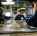 Lt. Cmdr. Freddie Koonce, from Kinston, North Carolina, explains flight deck operations to Commodore Andrew Betton