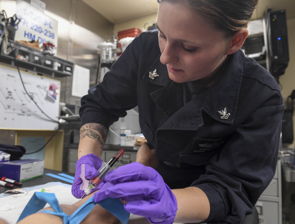 USS Wayne E. Meyer (DDG 108) Sailor Practices Phlebotomy