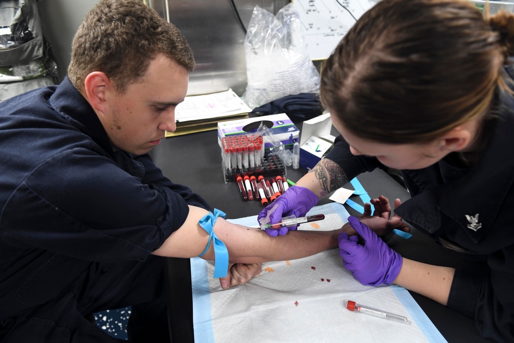 USS Wayne E. Meyer (DDG 108) Sailor Practices Phlebotomy