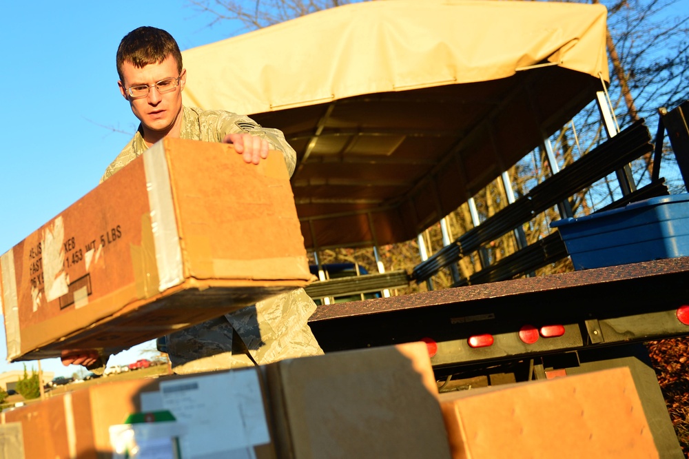 Airman carries cargo crates