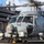 170123-N-BL637-034 A U.S. Navy MH-60R Seahawk helicopter numbered '714' is on the flight deck of an aircraft carrier, with its rotors spinning and a pilot visible in the cockpit. The scene shows active flight deck operations with multiple aircraft and personnel visible. A warning sign reading 'BEWARE JET BLAST' is visible on the carrier's island superstructure in the background.