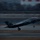 Lightning II strikes Iwakuni, F-35B arrives A U.S. Marine Corps F-35B Lightning II stealth fighter jet is captured during takeoff or landing on a runway at dusk or dawn. The aircraft displays green navigation/formation lights and has its landing gear deployed. The panning camera technique creates motion blur in the background, emphasizing the aircraft's speed.