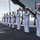170117-N-BL637-102 A U.S. Navy honor guard is performing a ceremonial rifle detail on the flight deck of a naval vessel at sea. The sailors are dressed in formal white dress uniforms and are holding rifles with bayonets attached, standing in a precise line formation. One sailor at the far left appears to be rendering a salute, suggesting this is a formal military ceremony such as a burial at sea or memorial service.