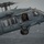 170123-N-VN584-120 A U.S. Navy MH-60S Seahawk helicopter is captured in flight over open ocean water. The aircraft is assigned to the USS Theodore Roosevelt, as indicated by text visible on the fuselage. A crew member in tactical gear is visible in the open side door while a pilot is seen in the cockpit.