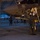 Lightning II strikes Iwakuni, F-35B arrives Military personnel are conducting pre-flight or post-flight inspection of an F-35 fighter jet inside a hangar during low-light conditions. A pilot in full flight gear and helmet is examining the underside/fuselage area of the aircraft, which bears the number '07' and a U.S. military star insignia. Additional personnel are visible in the background within the large hangar structure.
