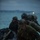 31st Marine Expeditionary Unit completes MEUEX A group of military personnel in camouflage uniforms and tactical helmets are hauling a black inflatable rubber raiding craft (IBS/Zodiac-type boat) onto a beach during low-light conditions, likely dusk or dawn. The soldiers have face paint applied in dark camouflage patterns, suggesting a covert or amphibious assault exercise. This appears to be a military amphibious landing drill or reconnaissance operation conducted near a coastal shoreline.