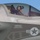 Marine Corps Air Station Camp Pendleton Tests its F-35 Capabilities A close-up photograph of an F-35 Lightning II fighter jet cockpit with a pilot seated inside wearing a flight helmet and visor. The aircraft displays U.S. military markings including a roundel (star and bars insignia) and the tail number '04'. Multiple safety and rescue markings are clearly visible on the fuselage.