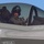 Marine Corps Air Station Camp Pendleton Tests its F-35 Capabilities A military pilot is seated in the cockpit of what appears to be an F-35 Lightning II stealth fighter jet. The pilot is wearing a flight helmet and olive-green flight suit, visible through the open canopy. Several safety markings and warnings are clearly visible on the aircraft's fuselage.