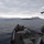 170123-N-JI086-187 A naval warship, consistent with a US Navy Arleigh Burke-class guided-missile destroyer, is underway in calm coastal waters with mountainous terrain visible in the background. The photo is taken from an elevated position on the ship's superstructure looking forward along the main deck. Weather conditions are overcast with snow-capped mountains visible in the distance, suggesting a cold-weather Mediterranean or similar coastal environment.