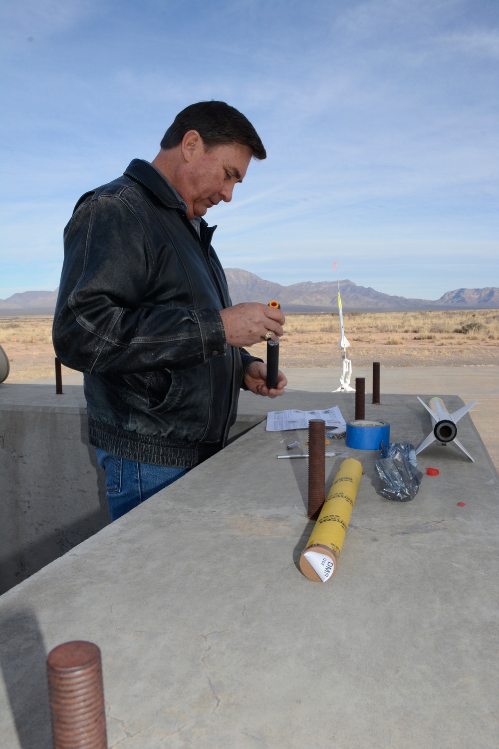 Electronics Engineer Jim Cutler works on the model rocket