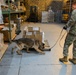 Military Working Dog and Handler Train in a Hangar