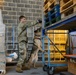 Military Working Dog and Handler Train in a Hangar