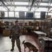 Military Working Dog and Handler Train in a Hangar