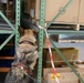 Military Working Dog and Handler Train in a Hangar