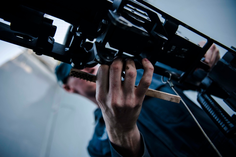 USS Green Bay Gunner’s Mates conduct maintenance on M240B machine guns