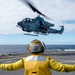 Helicopters land aboard USS Green Bay’s flight deck during patrol