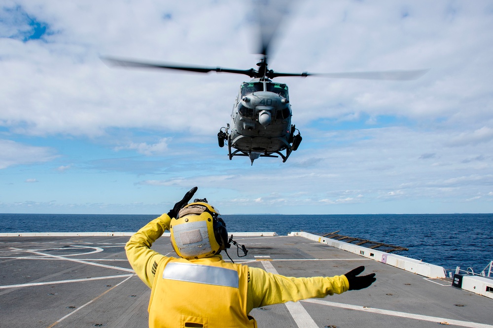 Helicopters land aboard USS Green Bay’s flight deck during patrol