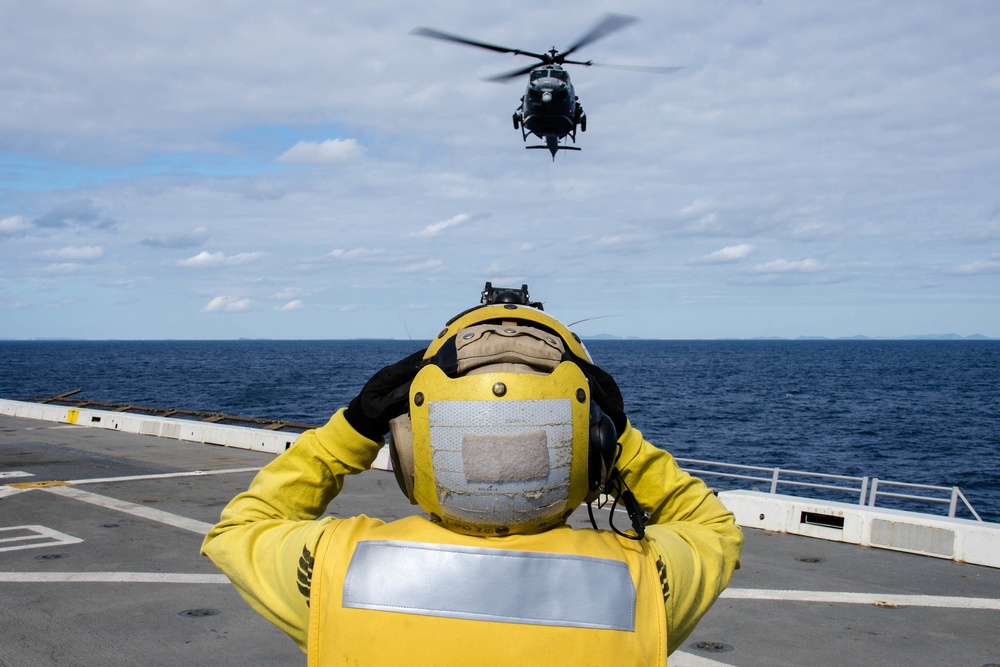 Helicopters land aboard USS Green Bay’s flight deck during patrol