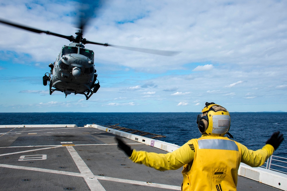 Helicopters land aboard USS Green Bay’s flight deck during patrol