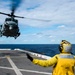 Helicopters land aboard USS Green Bay’s flight deck during patrol