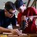 Coast Guard volunteers help students build SeaPerch underwater robots