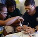 Coast Guard volunteers help students build SeaPerch underwater robots