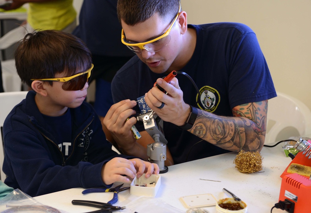 Coast Guard volunteers help students build SeaPerch underwater robots