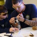 Coast Guard volunteers help students build SeaPerch underwater robots