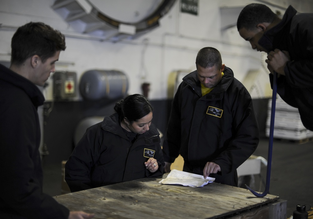 Nimitz Sailors check paperwork