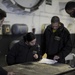 Nimitz Sailors check paperwork
