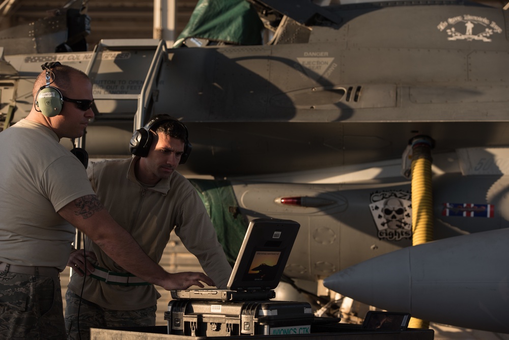 Prepping an F-16 for weapons load